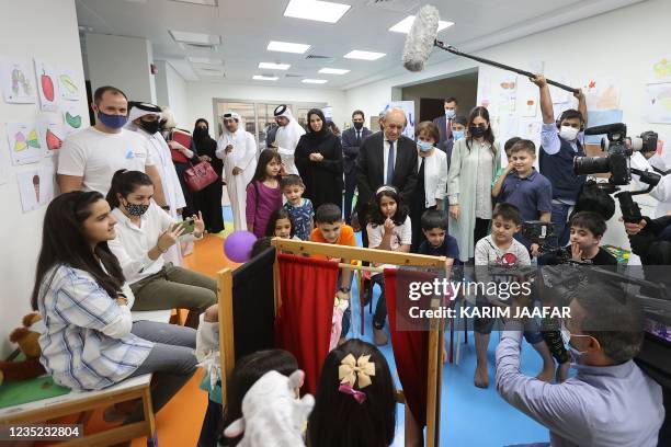 French Foreign Minister Jean-Yves Le Drian , accompanied by Qatars assistant Foreign Minister Lolwah al-Khater , visits refugees from Afghanistan at...