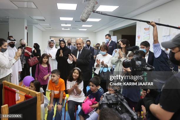 French Foreign Minister Jean-Yves Le Drian , accompanied by Qatars assistant Foreign Minister Lolwah al-Khater , visits refugees from Afghanistan at...