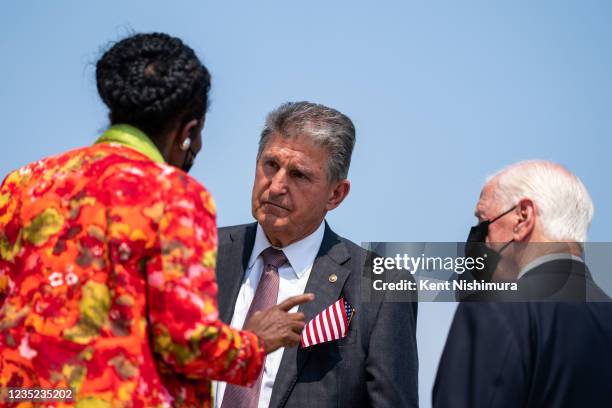 Rep. Sheila Jackson Lee , left, and Rep. Mike Thompson , right, speak with Sen. Joe Manchin , center, following a remembrance ceremony marking the...