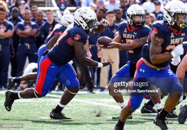 Navy Midshipmen quarterback Xavier Arline hands the ball off to fullback James Harris II during the Air Force game versus the Navy on September 11,...