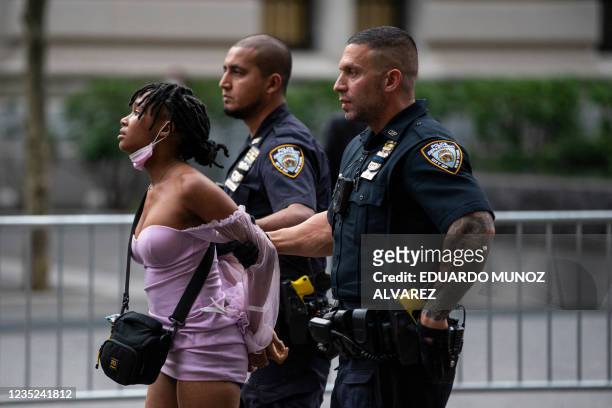 Woman gets arrested during a "Defund the Police" protest outside the Metropolitan Museum of Art during the MET Gala in New York on September 13, 2021.