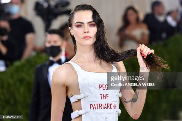 English model Cara Delevingne arrives for the 2021 Met Gala at the Metropolitan Museum of Art on September 13, 2021 in New York. - This year's Met...