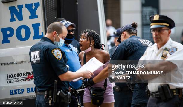 Protester gets arrested during a "Defund the Police" protest outside the Metropolitan Museum of Art during the MET Gala in New York on September 13,...