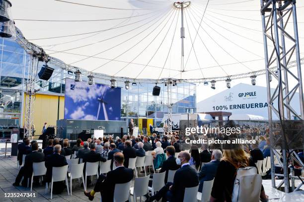September 2021, Schleswig-Holstein, Husum: Trade fair visitors and exhibitors sit in front of a stage during the opening of the trade fair. From 14...