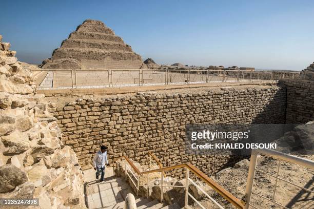 Man walks out of the southern cemetery near the step pyramid of the third dynasty Ancient Egyptian king Djoser at the Saqqara Necropolis south of...