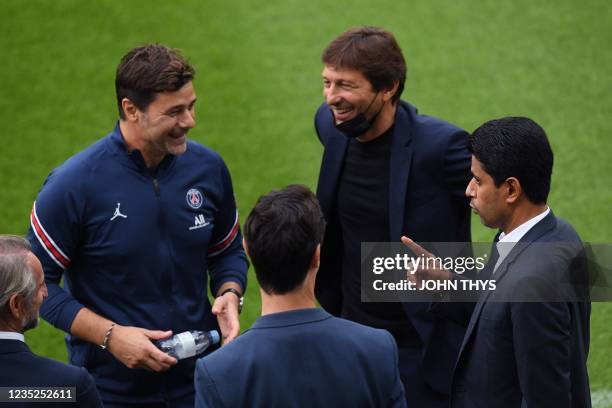 Paris Saint-Germain's Qatari President Nasser Al-Khelaifi chats with Paris Saint-Germain's Argentinian head coach Mauricio Pochettino and Paris...