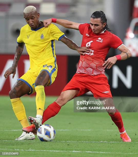 Nassr's midfielder Talisca is marked by Tractor's midfielder Akbar Imani during the AFC Champions League Round of 16 football match between Saudi's...