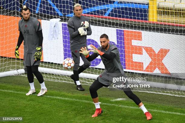 Paris Saint-Germain's Italian goalkeeper Gianluigi Donnarumma grabs a ball past Paris Saint-Germain's Costa Rican goalkeeper Keylor Navas and Paris...