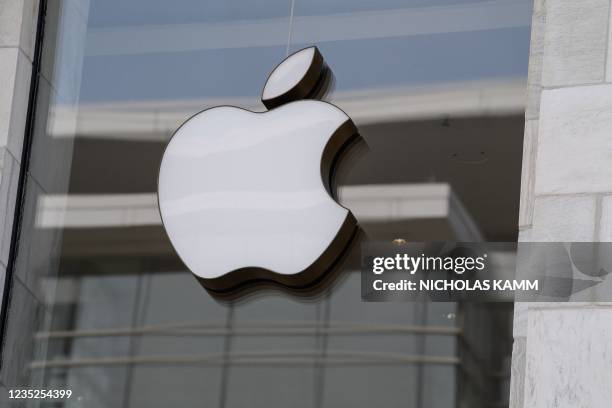 The Apple logo is seen at the entrance of an Apple store in Washington, DC, on September 14, 2021. - Apple users were urged on Tuesday to update...