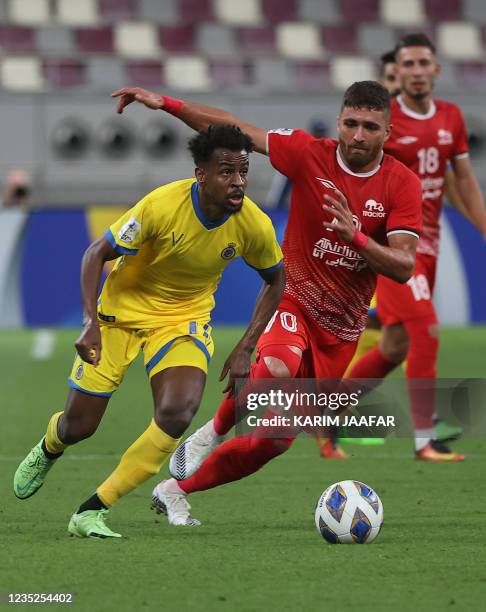 Nassr's midfielder Abdullah al-Khaibari is marked by Tractor's forward Amin Asadi during the AFC Champions League Round of 16 football match between...