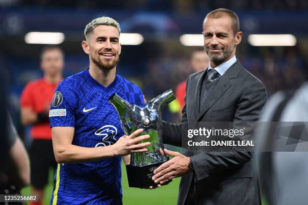 Chelsea's Italian midfielder Jorginho is presented with the UEFA men's player of the year award before the UEFA Champions League Group H football...