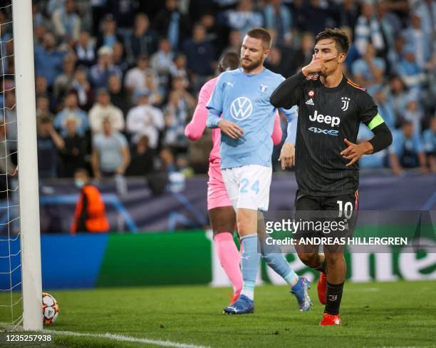 Juventus' Argentinian forward Paulo Dybala celebrates scoring the 0-2 goal from the penalty spot during the UEFA Champions League group H football...