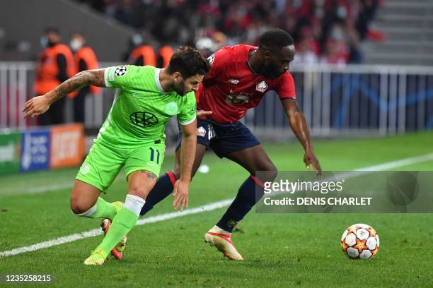Wolfsburg's Swiss midfielder Renato Steffen challenges Lille's French forward Jonathan Ikone during the UEFA Champions League group G football match...