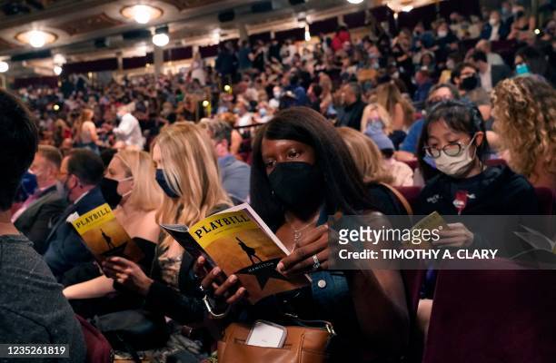 People wait in the audience at the Broadway musical "Hamilton" on September 14, 2021 in New York, as the highest grossing Broadway musical of all...