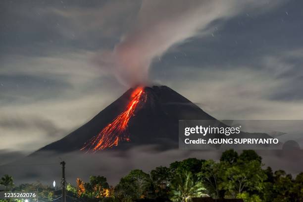 Lava flows down and smoke rises into the air from Mount Merapi, Indonesia's most active volcano, as seen from Wonokerto in Sleman on September 15,...