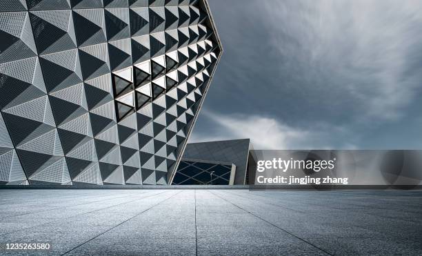 urban marble square with tall city and pyramid shape protruding from the side of three-dimensional building - arquitectura fotografías e imágenes de stock
