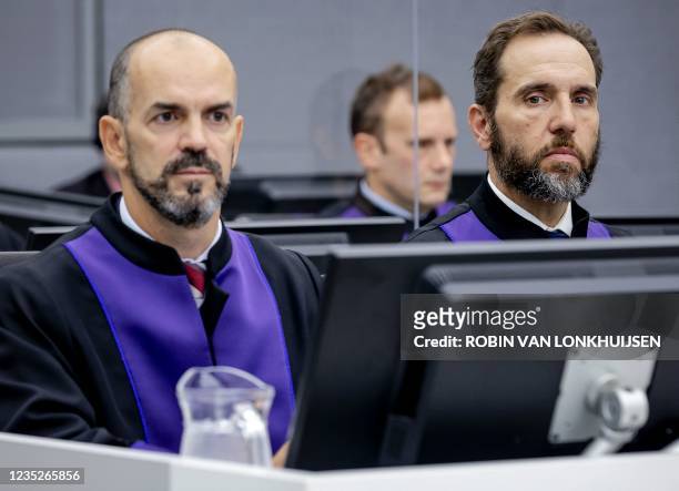 Prosecutor Jack Smith , and Cezary Michalczuk, look on as they wait for the start of Salih Mustafa, former commander in the Kosovo Liberation Army ,...