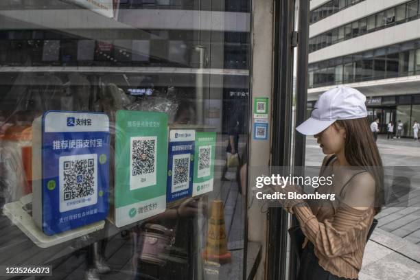 Codes for digital payment services Alipay by Ant Group Co. And WeChat Pay by Tencent Holdings Ltd. Displayed at a snack shop in Beijing, China, on...