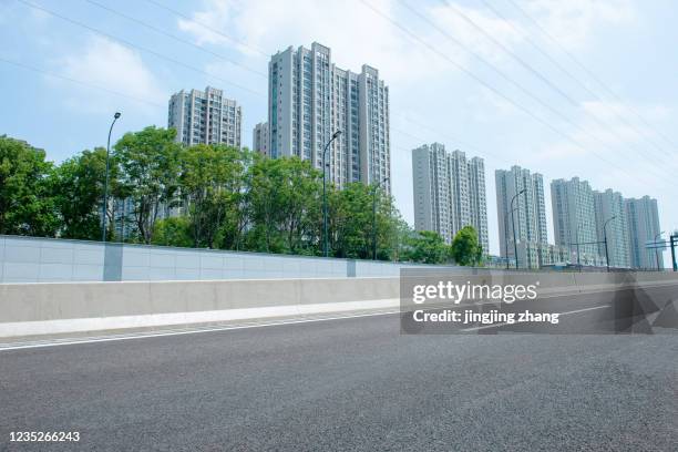 highways passing high-rise buildings in the city center - speed motion lines to the middle stock pictures, royalty-free photos & images