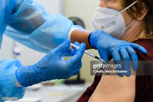 Medical staff member inoculates an elderly patient with a booster inoculation of the Pfizer/BioNTech vaccine against Covid-19 on September 15, 2021...