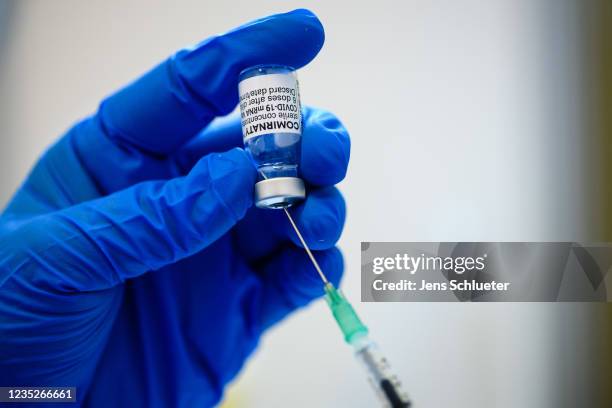 Medical Staff prepares a vial of the Pfizer/BioNTech Comirnaty vaccine against Covid-19 at a vaccination center on September 15, 2021 in Erfurt,...