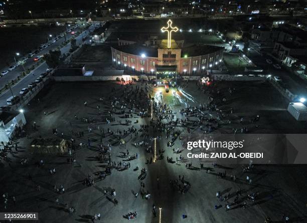 This picture taken on September 14, 2021 shows an aerial view of worshippers gathering outside the Syriac Catholic Church of the Immaculate...