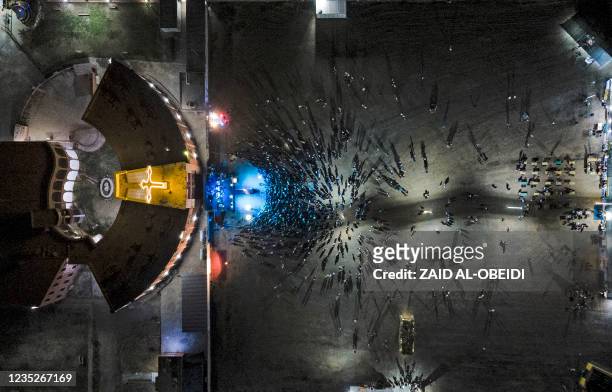 This picture taken on September 14, 2021 shows an aerial view of worshippers gathering outside the Syriac Catholic Church of the Immaculate...