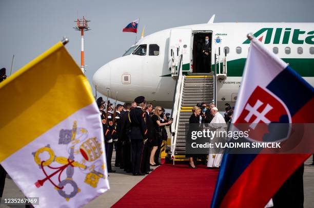 Slovak President Zuzana Caputova and Pope Francis shake hands in front of an Alitalia aircraft before the pontiff's departure from Bratislava's Milan...