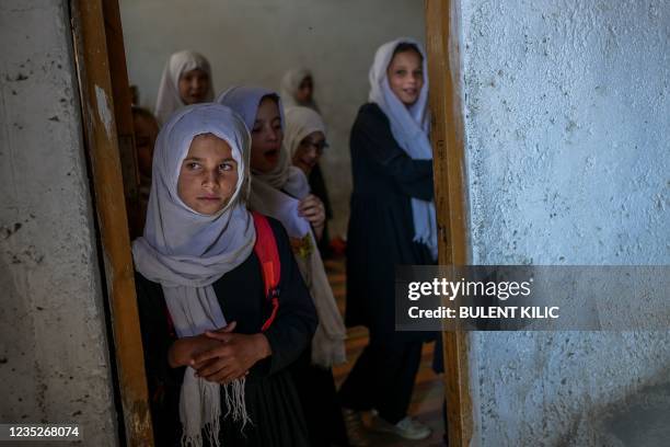 School girls gather at their class after arriving at a gender-segregated school in Kabul on September 15, 2021.