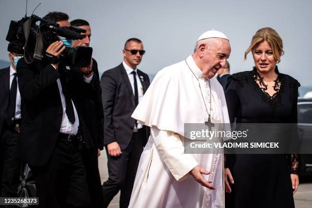 Slovak President Zuzana Caputova welcomes Pope Francis as ge gets off a limousine before his departure at Bratislava's Milan Rastislav Stefanik...