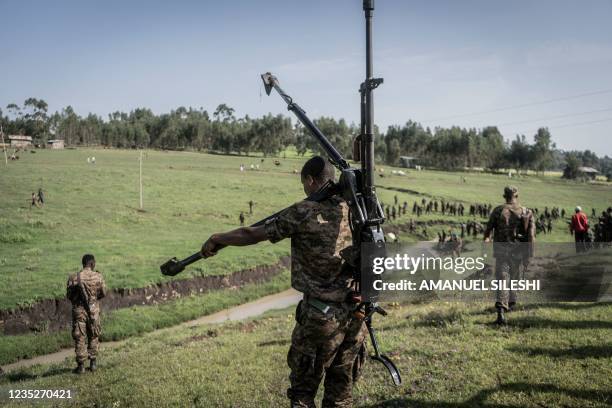 An Ethiopian National Defence Forces soldier carries a DShK 1938, a Soviet heavy machine gun, on his back during training in the field of Dabat, 70...