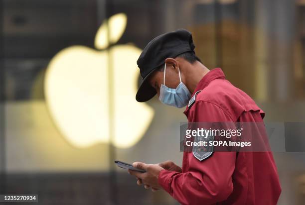 Pedestrian walks by the apple flagship store in Wangfujing, Beijing. Recently, apple held a new product launch in autumn where it released iPhone 13...