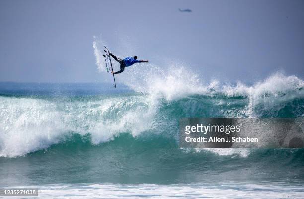 San Clemente, CA Former WSL world champion Italo Ferreira, of Brazil, soars high over a big wave while competing against fellow countryman Filipe...