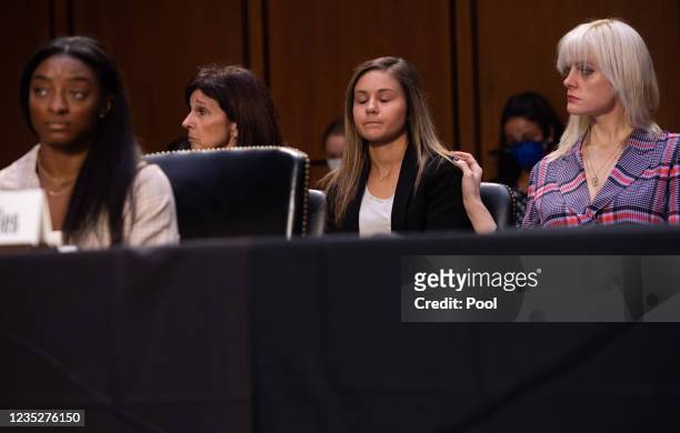 Gymnasts Jessica Howard and Kaylee Lorincz listen as U.S. Olympic gymnast Simone Biles testifies during a Senate Judiciary hearing about the...