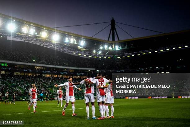Ajax's players celebrate Ivorian forward Sebastien Haller's goal during the UEFA Champions League first round group C football match between Sporting...
