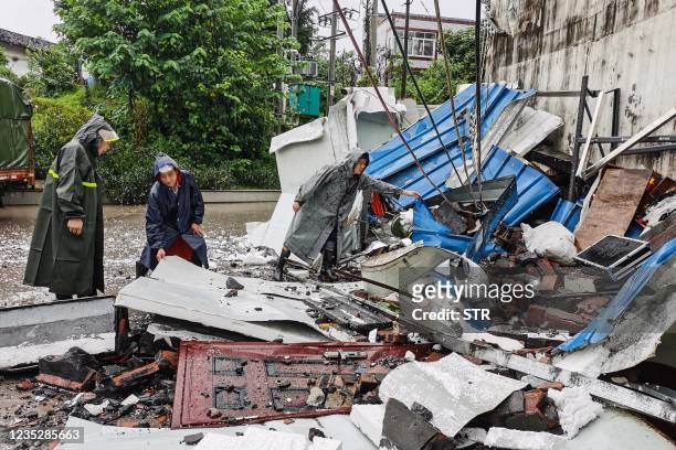Rescuers clean up debris after a 5.4 earthquake that killed three and injured a dozen in Luzhou, in China's southwestern Sichuan province on...