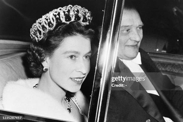 Queen Elizabeth II and French President Rene Coty are seen in a car on their way to the Opera Garnier in Paris during a state visit in France on...