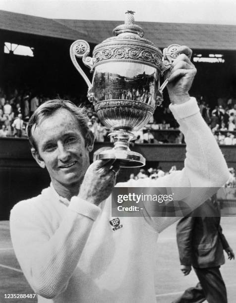 Australian tennis champion Rod Laver holds up the Wimbledon International tournament single men's trophy that he won, four-time consecutively,...