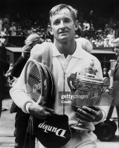 Australian tennis champion Rod Laver holds up the Wimbledon International tournament single men's trophy that he won, four-time consecutively,...