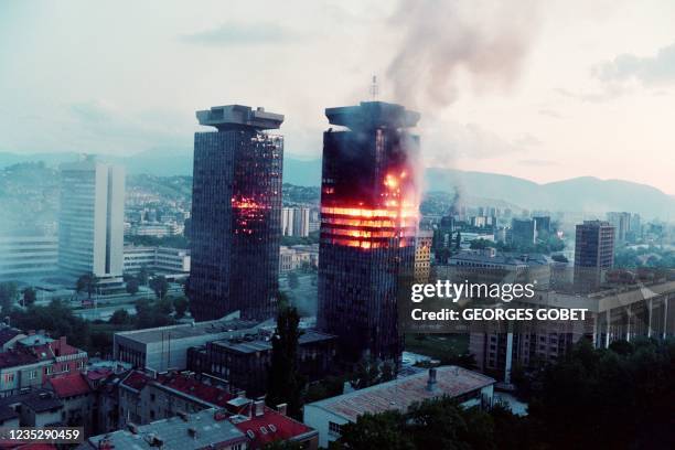 The "Momo" and "Uzeir" twin towers burn on Sniper Alley in downtown Sarajevo as heavy shellings and fightings raged throughout the Bosnian capital on...