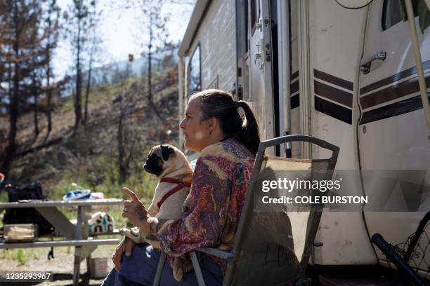 Christine Abbott with her dog Spudz camps just outside of Lytton, British Columbia, on September 3 after a wildfire destroyed their home this summer....