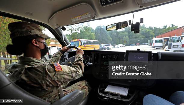 National Guard member Vegerano drives a school bus around the base with a safety trainer in Reading, MA on Sept. 15, 2021. About 90 members of the...