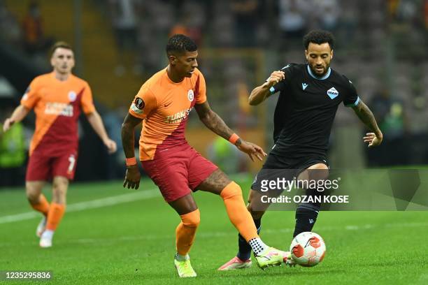 Galatasaray's Patrick van Aanholt fights for the ball with Lazio's Felipe Anderson during the UEFA Europa League group E football match between...