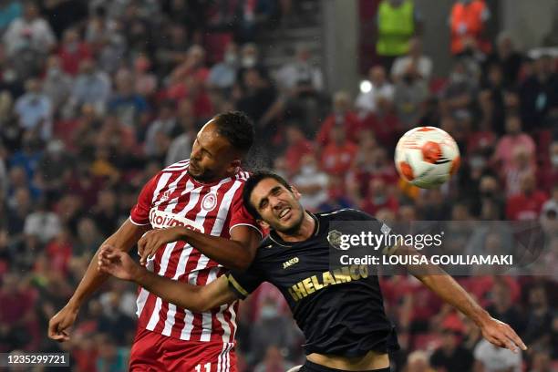 Olympiacos' Moroccan forward Youssef El-Arabi heads the ball and scores a goal past Antwerp's Portuguese defender Dinis Almeida during the UEFA...