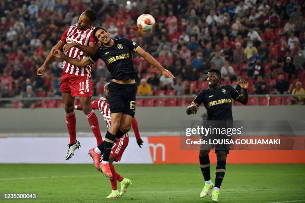 Olympiacos' Moroccan forward Youssef El-Arabi heads the ball and scores a goal past Antwerp's Portuguese defender Dinis Almeida during the UEFA...