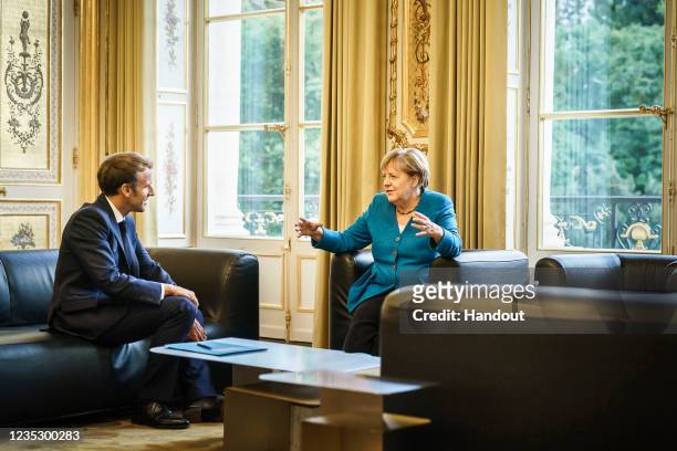 In this handout photo provided by the German Government Press Office , Chancellor Angela Merkel meets with French President Emmanuel Macron in the...
