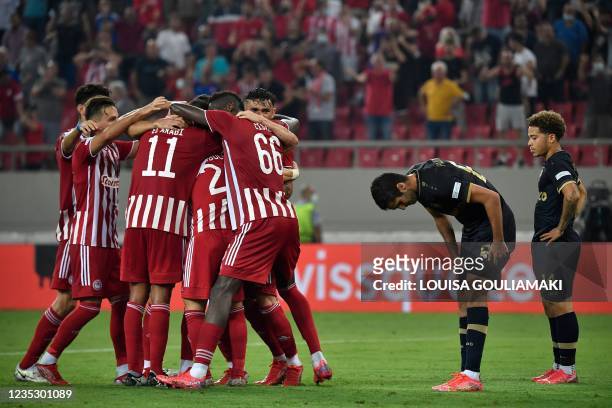 Olympiacos' Moldovan defender Oleg Reabciuk celebrates with teammates after scoring a goal during the UEFA Europa League Group D football match...