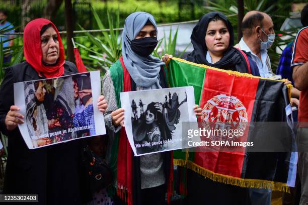 Afghan refugees hold pictures and an Afghanistan Flag during a demonstration against Pakistan in New Delhi. Afghan refugees residing in New Delhi,...