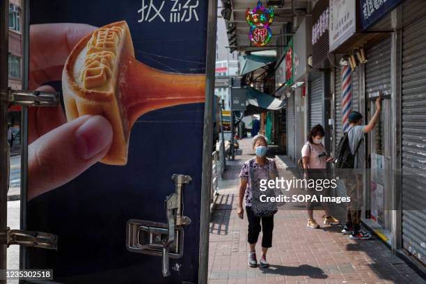 Pedestrian walks past a truck delivering Chinese bakery moon cake ahead of the Mid-Autumn Festival in Hong Kong.