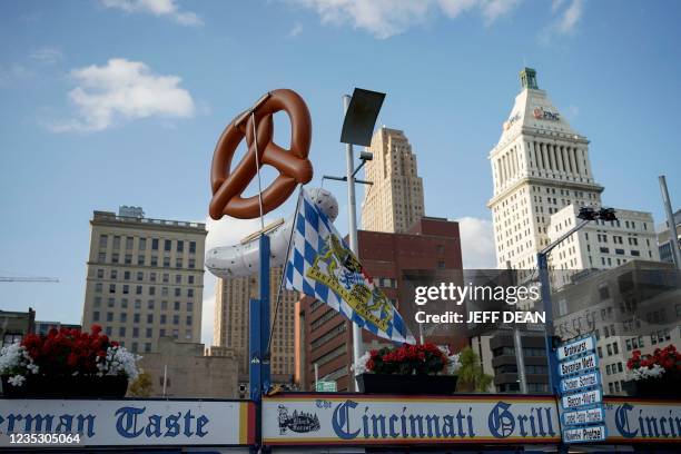 Giant pretzel and bratwurst are seen against the city skyline during Oktoberfest Zinzinnati in Cincinnati, Ohio on September 16, 2021. - Oktoberfest...